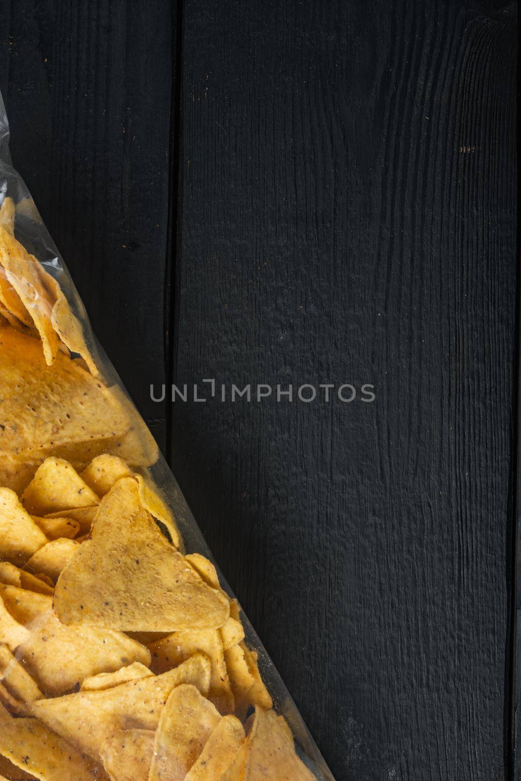 Package corn chips set, on black wooden background, top view or flat lay with copy space for text