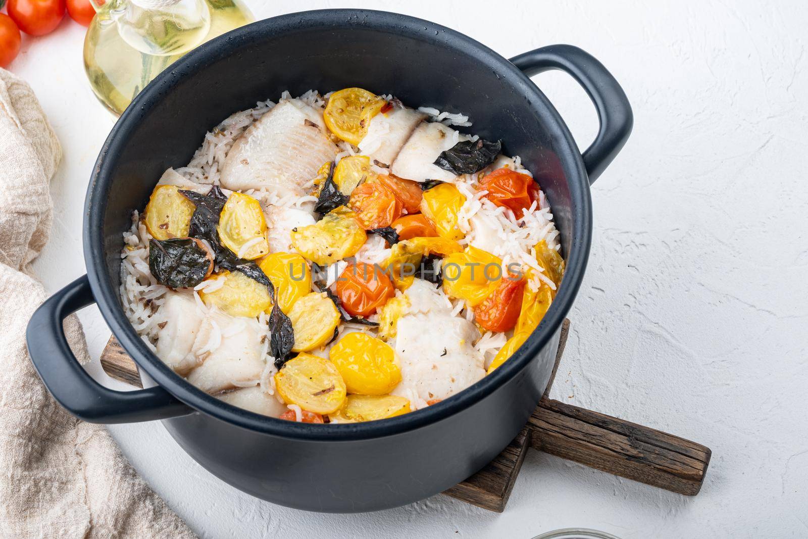 White tilapia fish, with basmati rice and cherry tomatoes, on white background