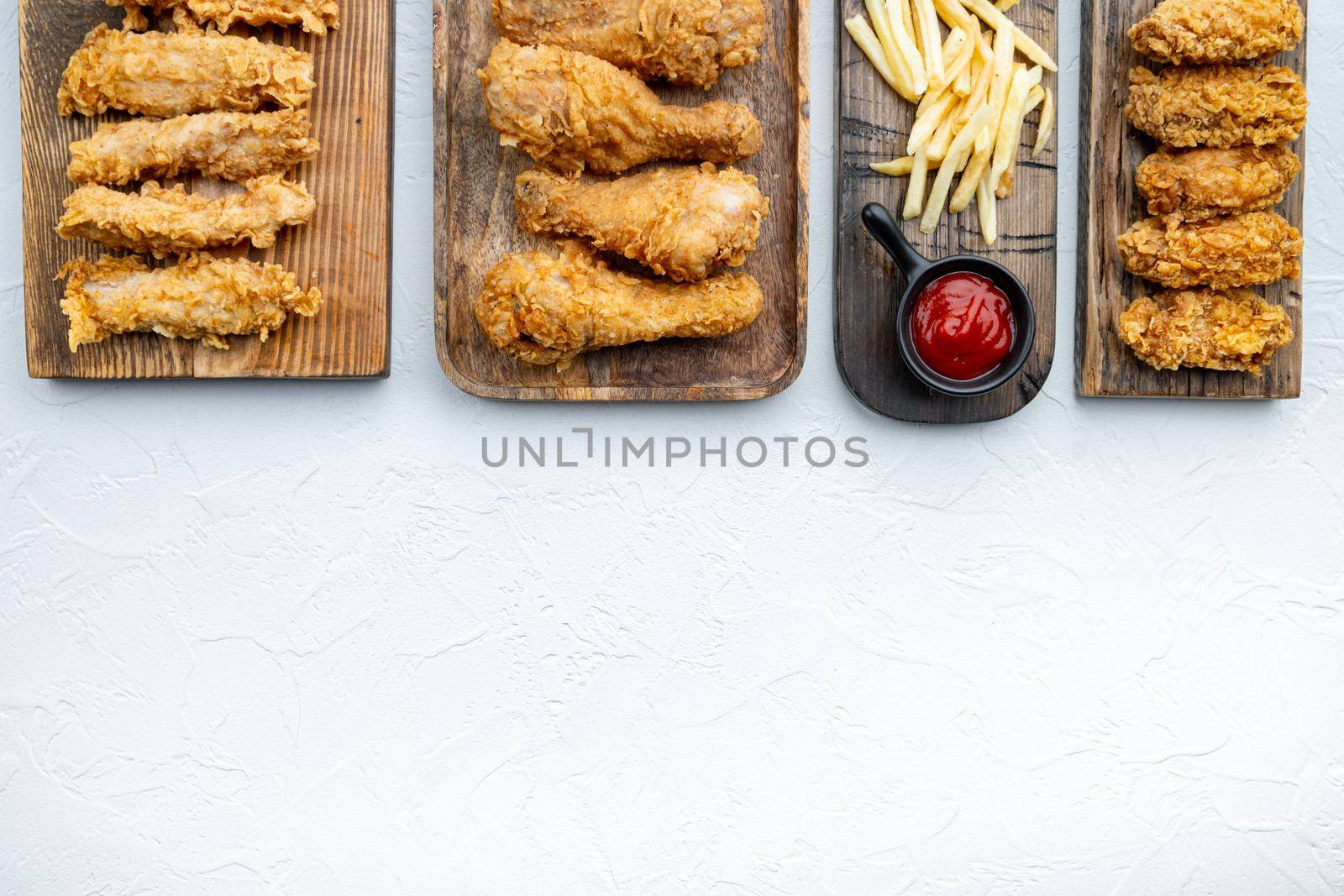 Southern fried chicken cuts on white background, top view, with space for text.