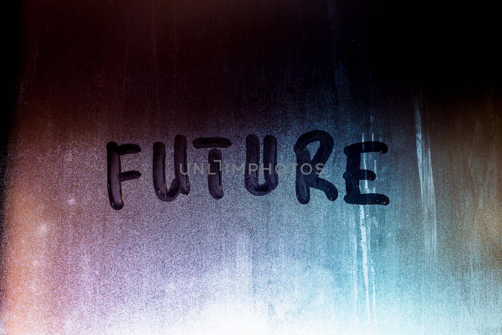 word future handwritten on night foggy window glass surface, close-up with selective focus