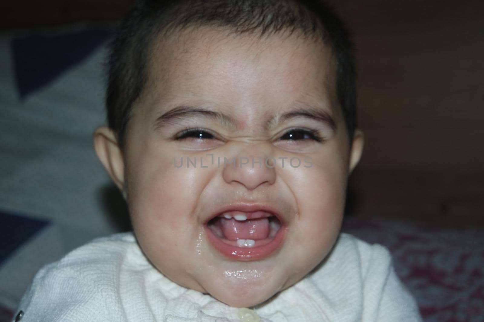 Baby girl with lovely face, big eyes and cute face gesture. Toddler baby making sweet activities