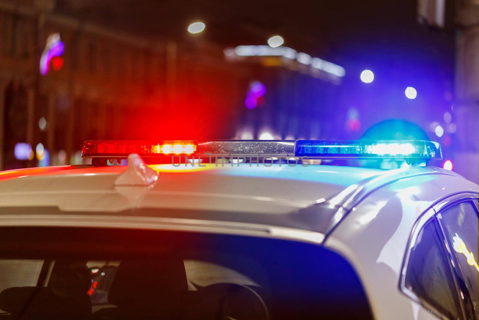 police car lights at night in city with selective focus and bokeh.