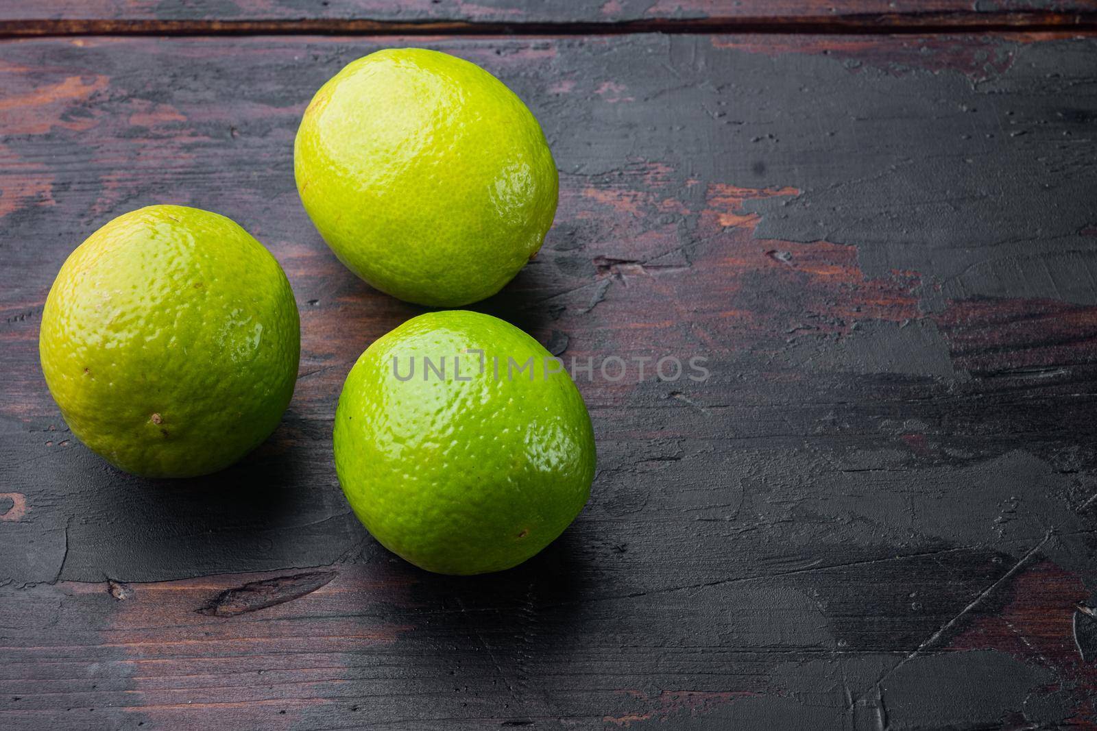 Whole green lime set, on old wooden table