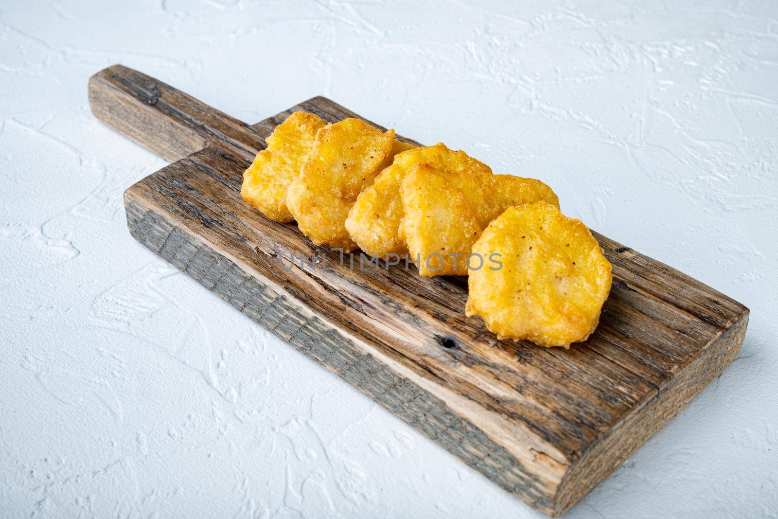 Chicken nuggets fried on white background.
