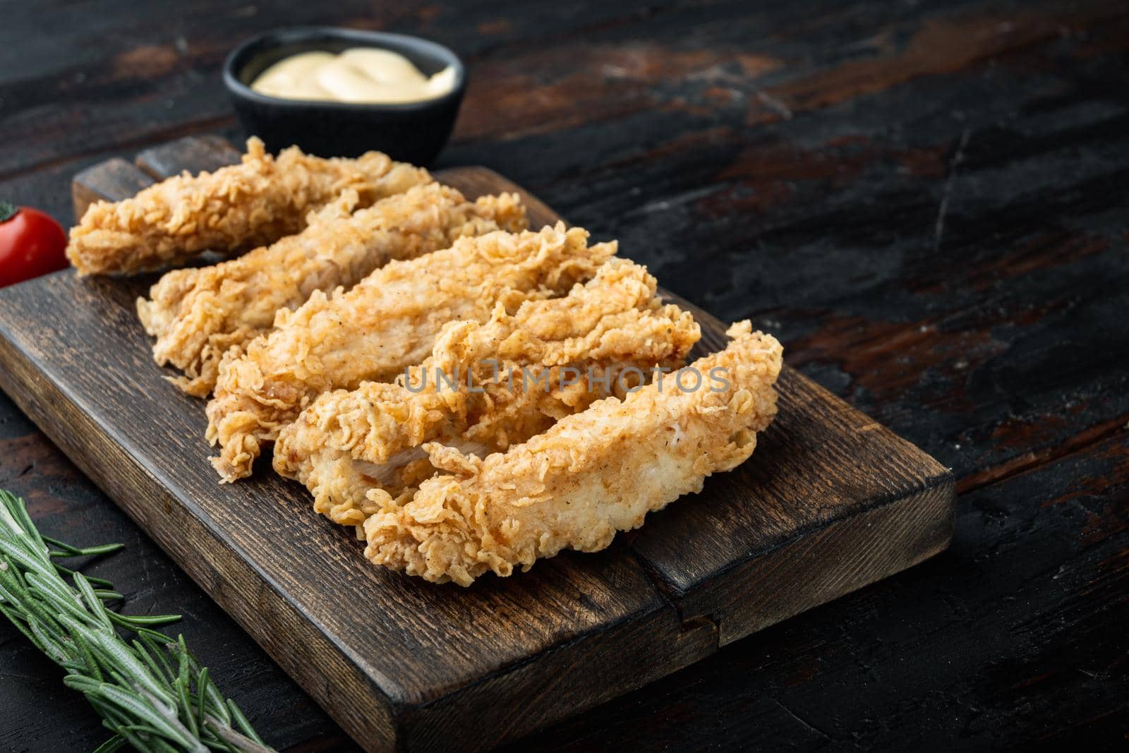 Chicken breaded wingshell meat on old dark wooden table, with copy space.
