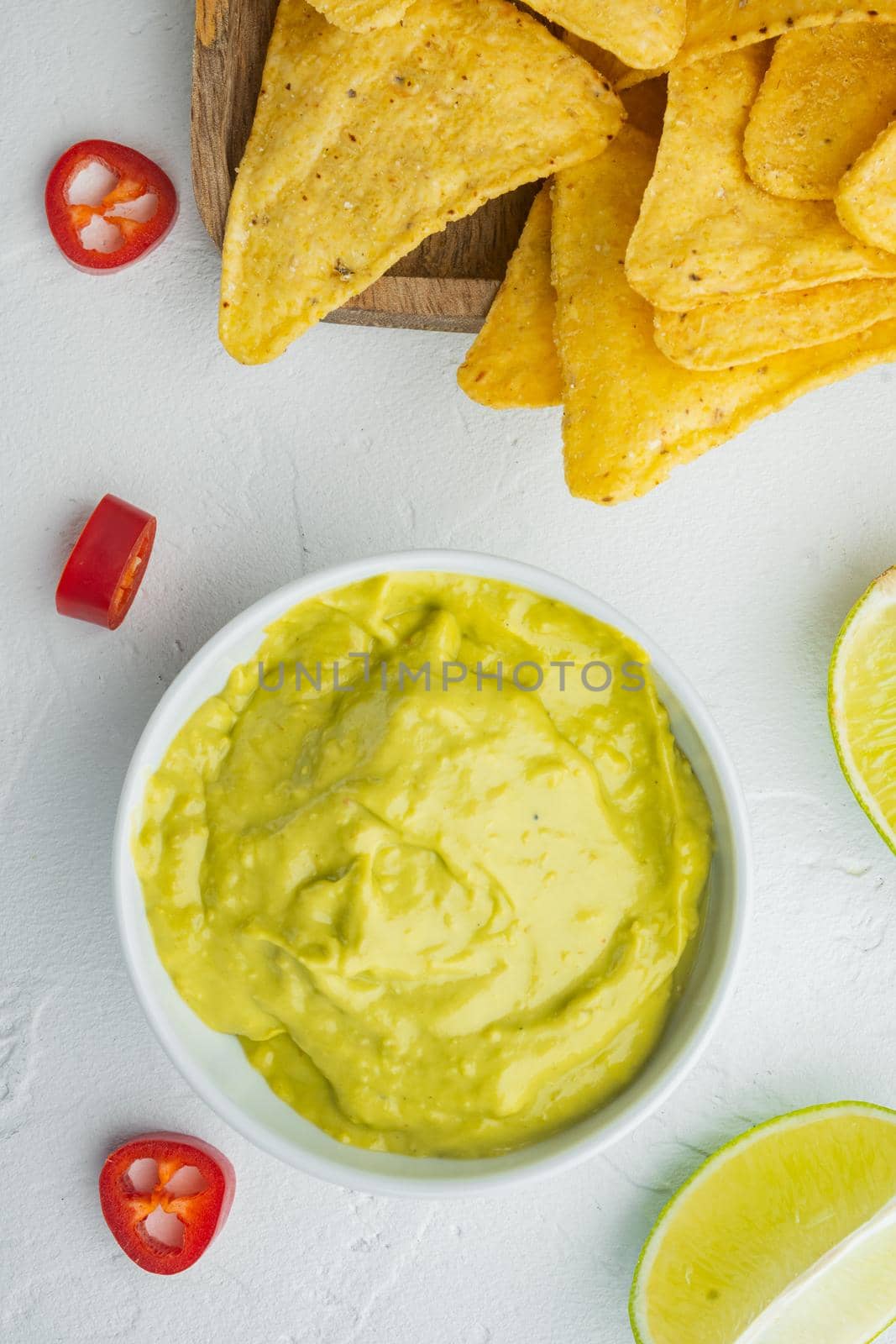 Guacamole freshly cooked and served in bowl, on white background, top view or flat lay