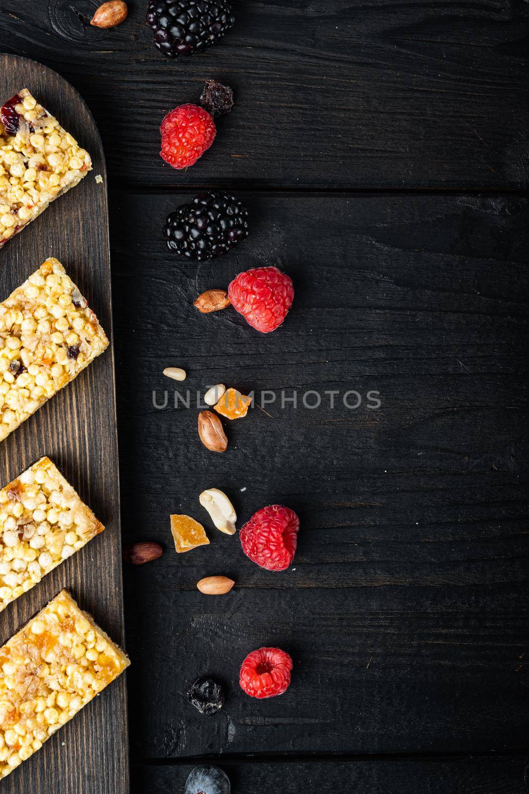 Healthy snacks, fitness lifestyle and high fiber diet concept, top view with copy space, on black wooden table by Ilianesolenyi