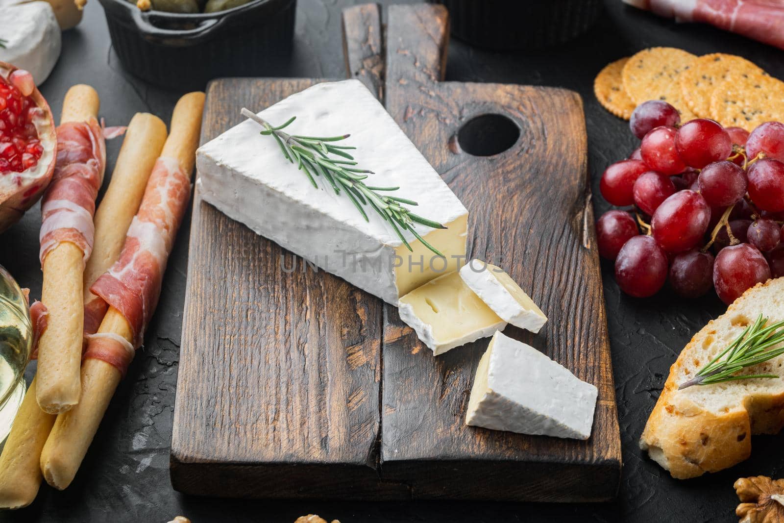 Slice of brie farmhouse creamy soft cheese set, on black background