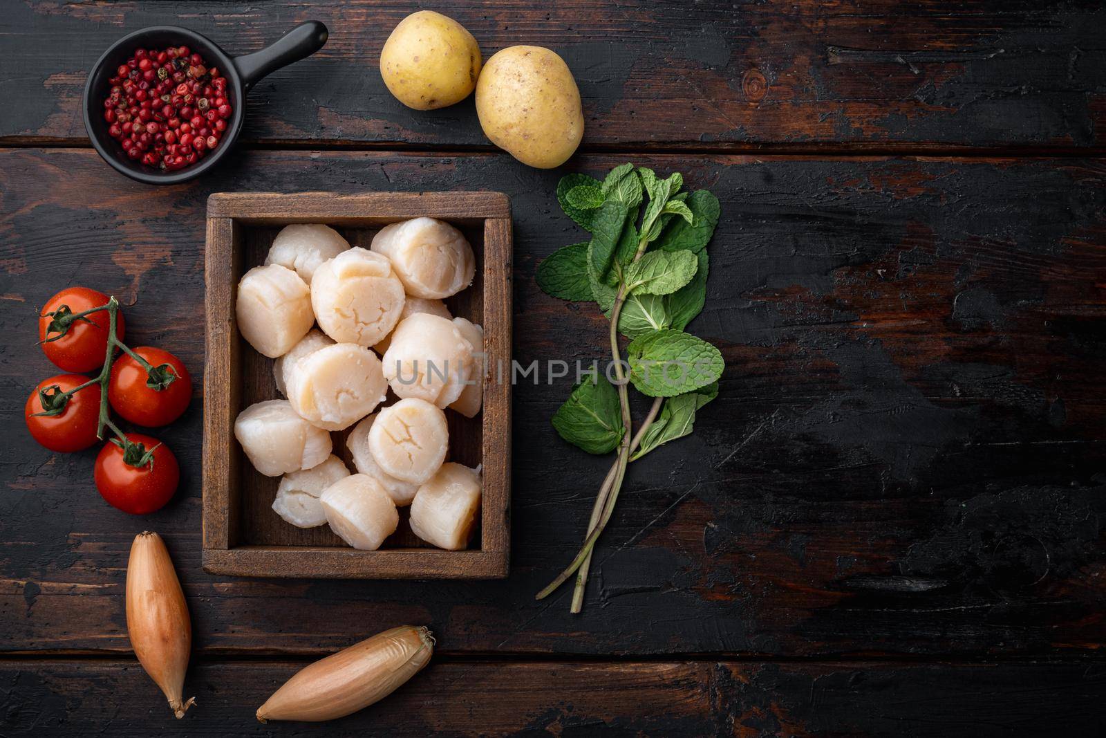 Sizzling seared scallops ingredient, top view, on dark wooden background with copy space