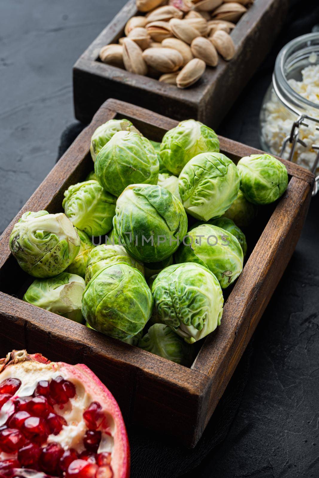 Gnarly garlic brussels ingredient, on black textured background
