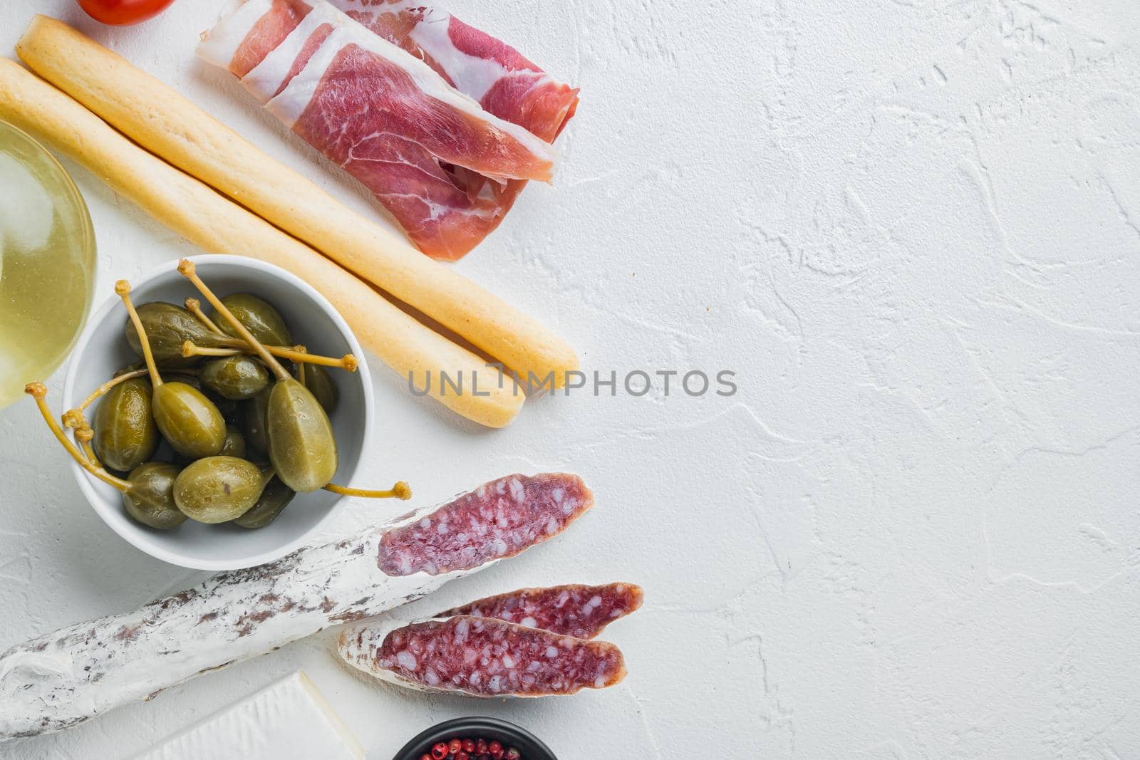 Italian snacks, meat cheese, herbs set, on white background, top view with copy space for text