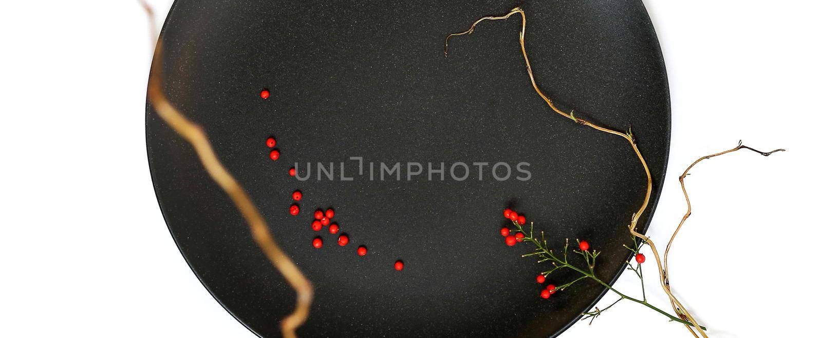 Ikebana with black round plate, Japanese bamboo on white background. Japanese inspiration, ikebana. elegant floral arrangement