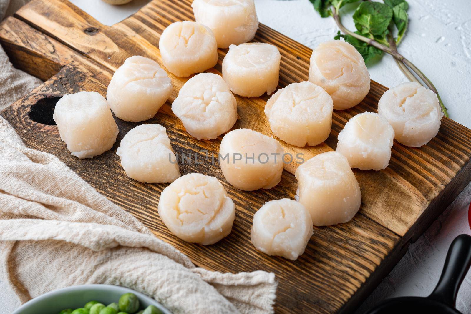 Raw fresh scallops meat, on white textured background