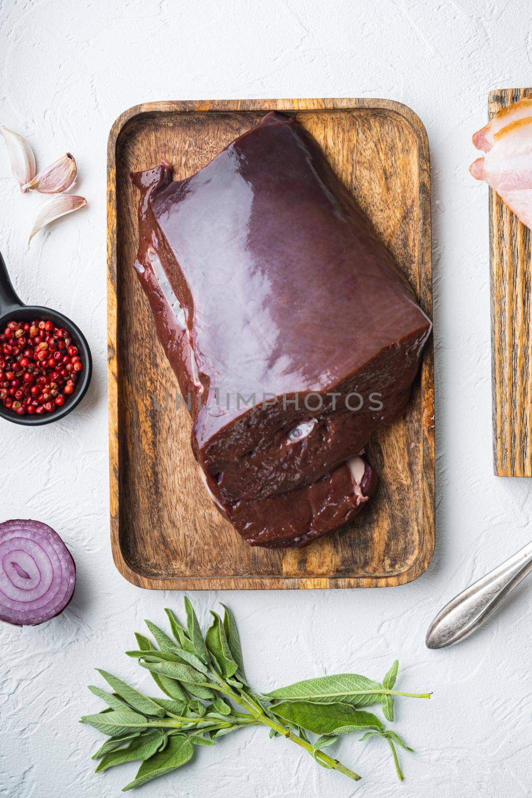 Beef liver with smoked bacon on white background, top view by Ilianesolenyi