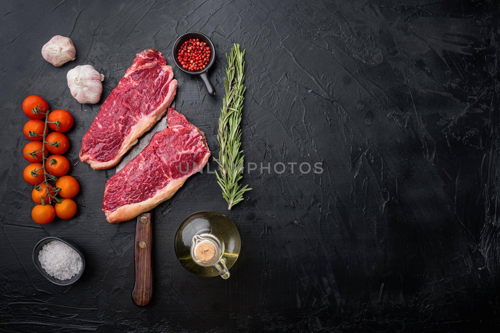 Kansas city raw organic beef steak cut, on black background, top view, with copy space for text