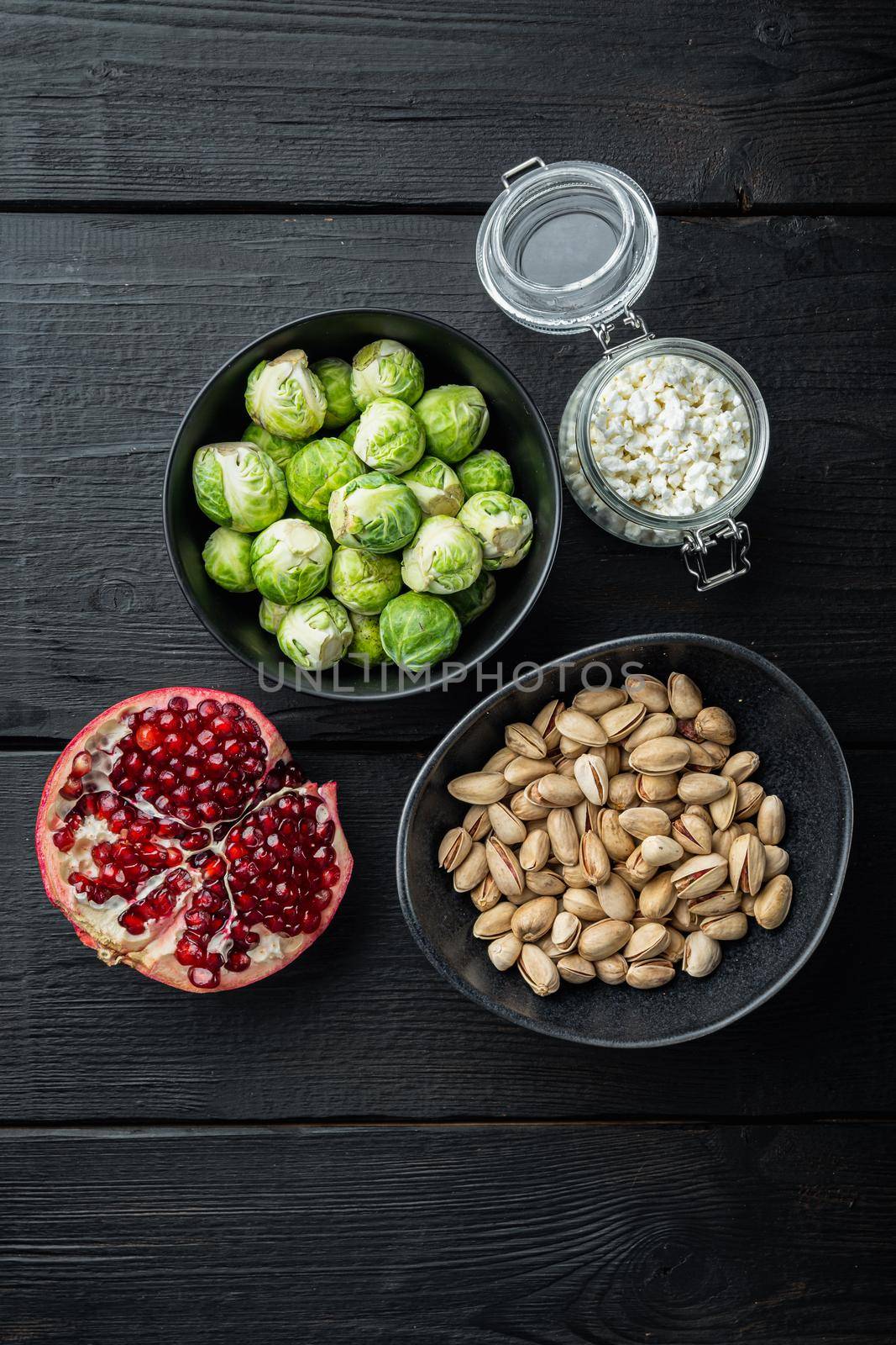 Gnarly garlic brussels ingredients, on black wooden table, top view by Ilianesolenyi