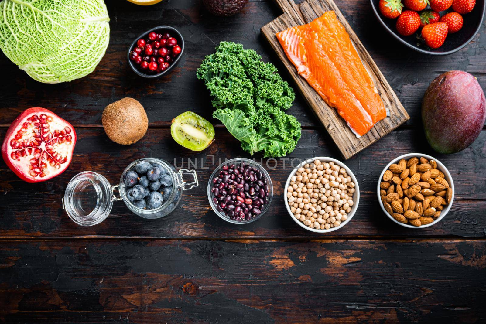 Superfoods dieting concept, top view on dark wooden background, with copy space by Ilianesolenyi