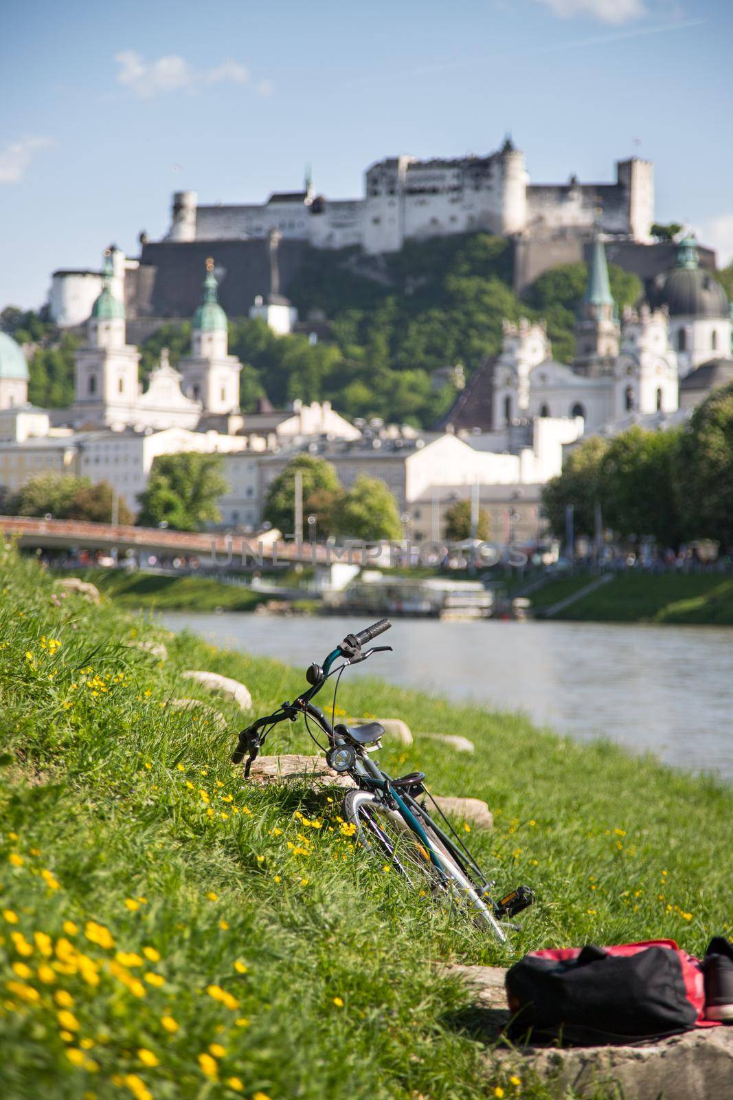 Panoramic city landscape of Salzburg in Summer, Bicycle in the foreground.