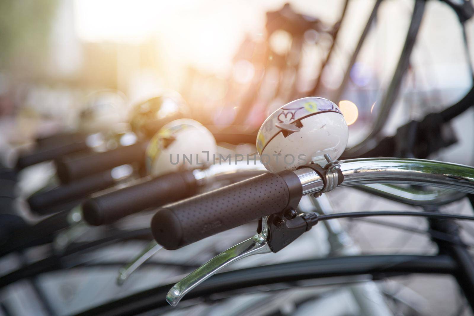 Colorful bike bells on parked bikes, urban city life