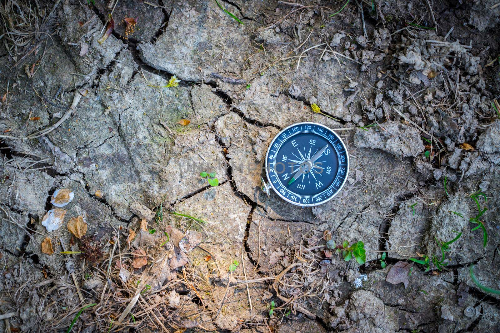 Vintage compass lying on the floor. Adventure and discovery concept.