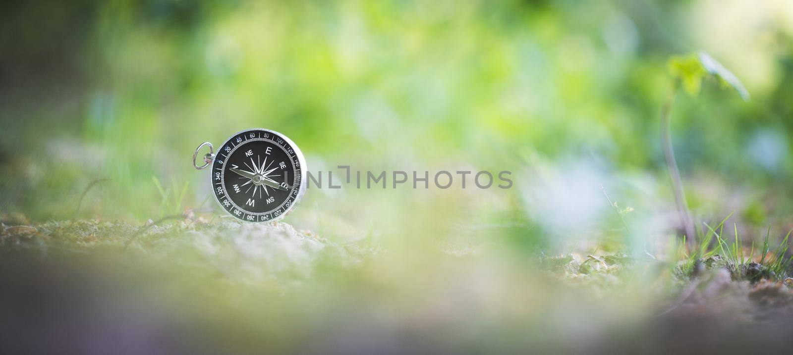 Vintage compass lying on the floor. Adventure and discovery concept.