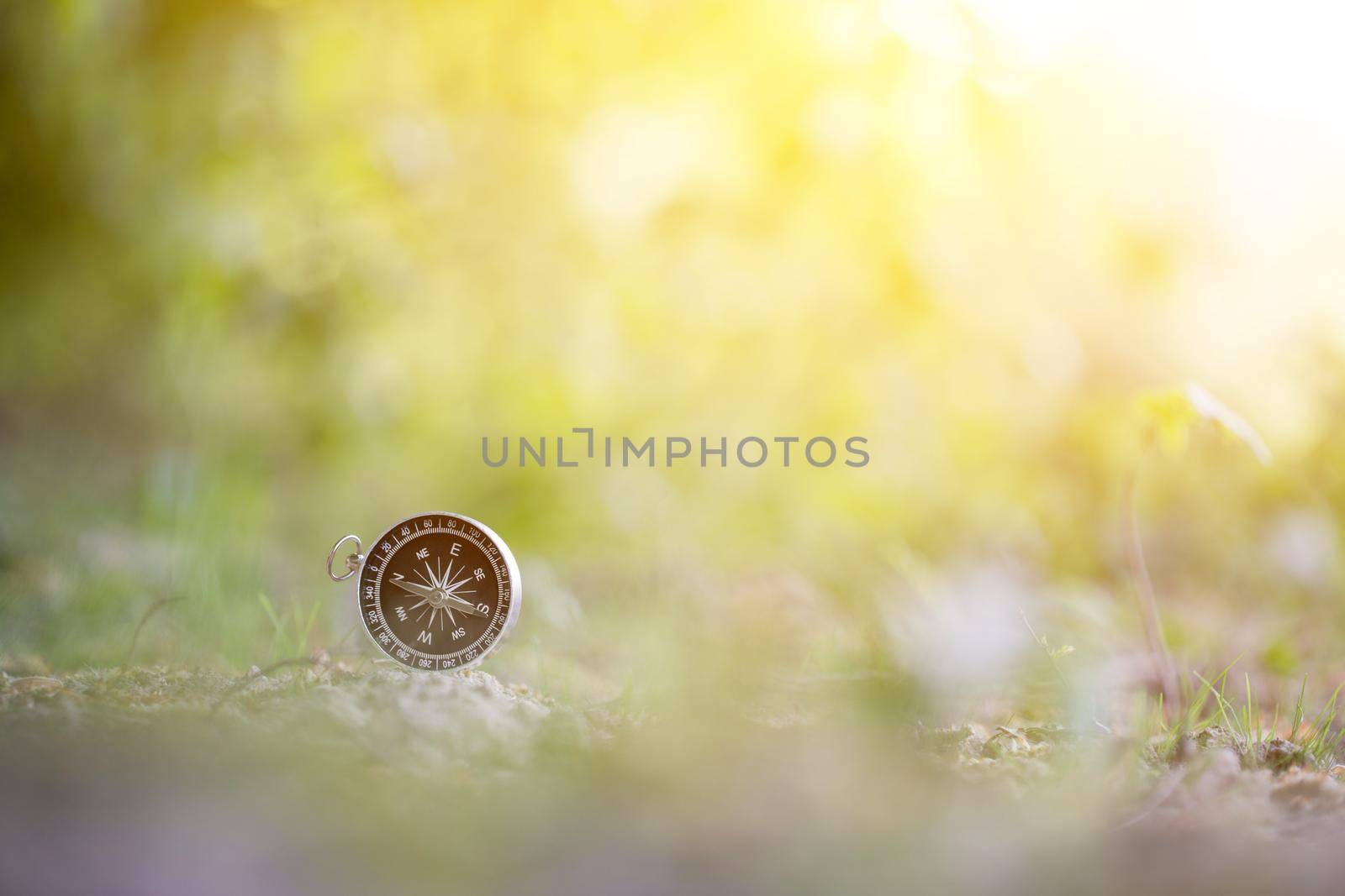 Vintage compass lying on the floor. Adventure and discovery concept.
