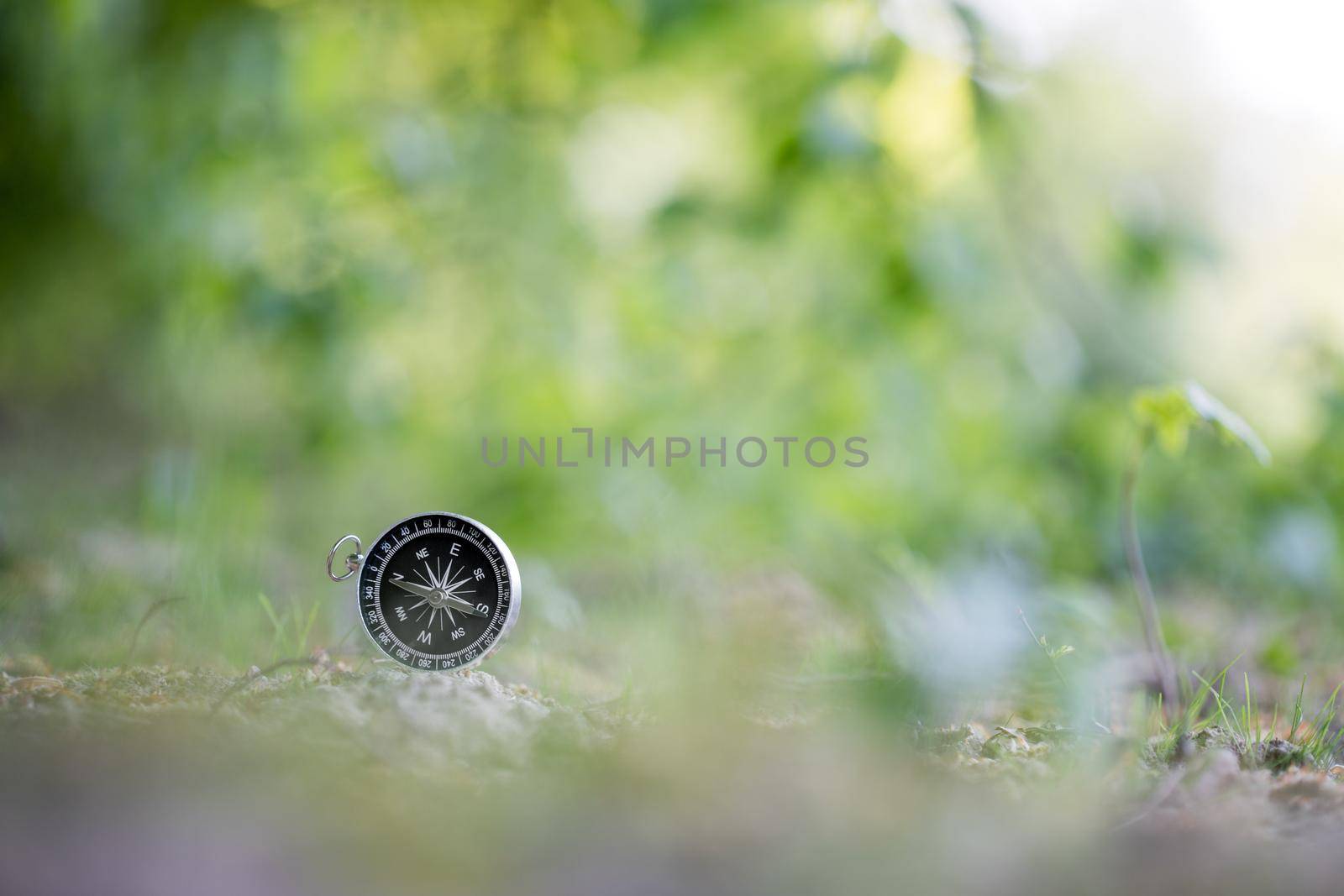 Vintage compass lying on the floor. Adventure and discovery concept.