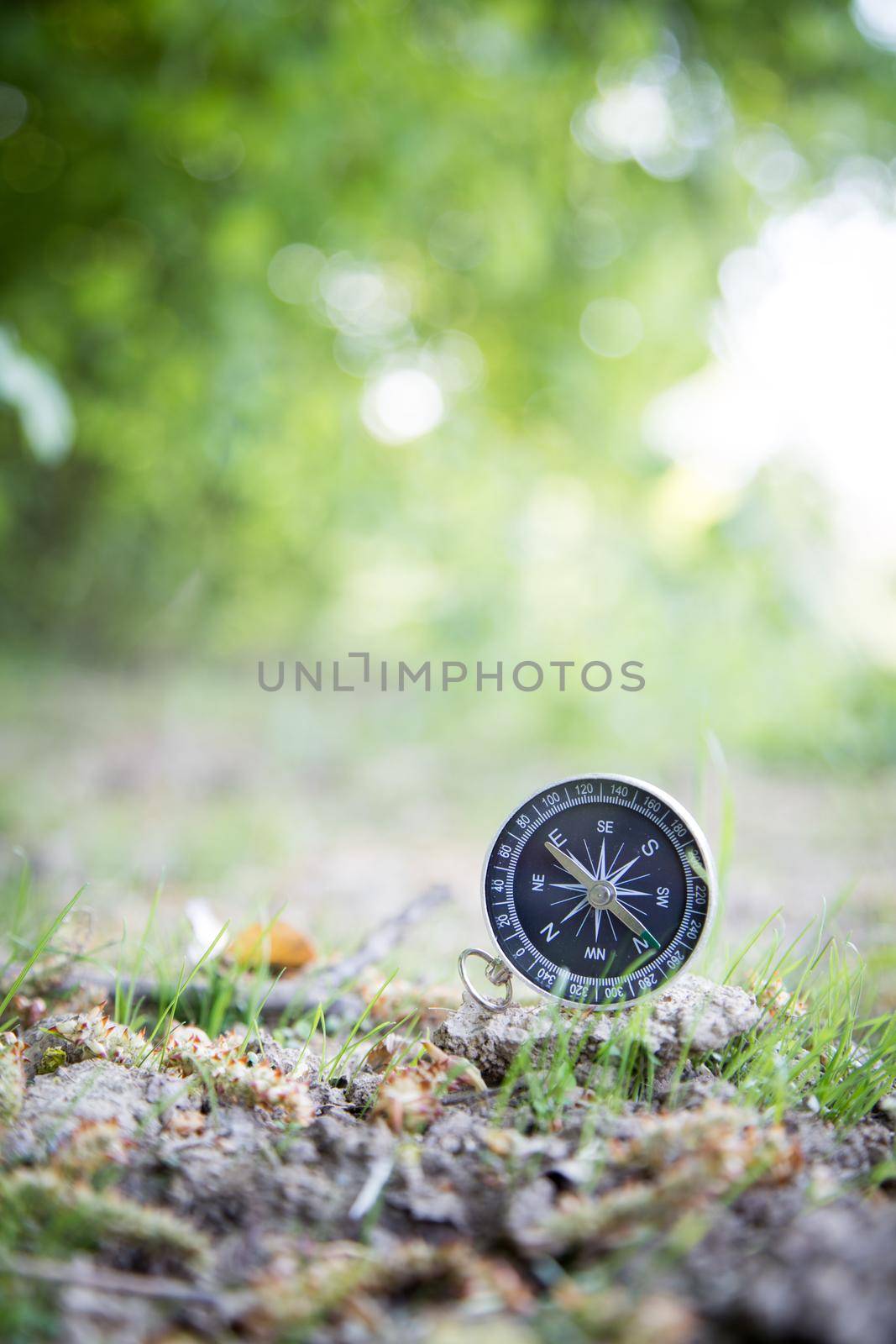 Vintage compass lying on the floor. Adventure and discovery concept.