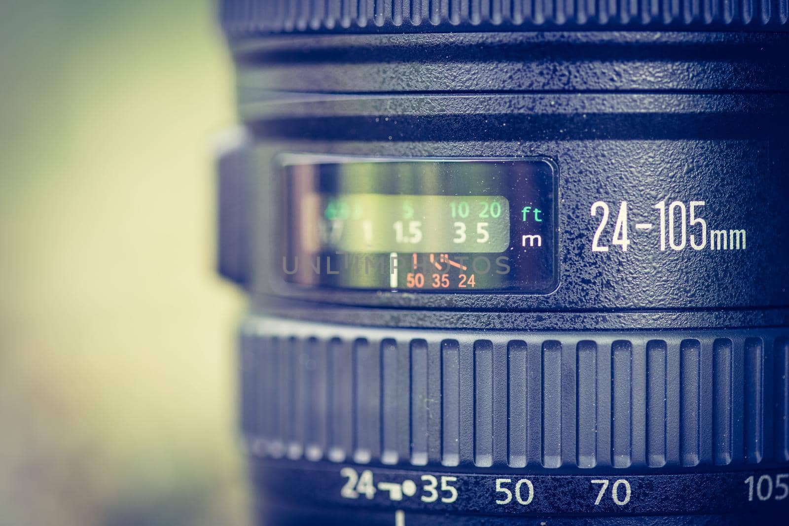 Professional optic photo lens outdoors. Warm colors, blurry background. by Daxenbichler