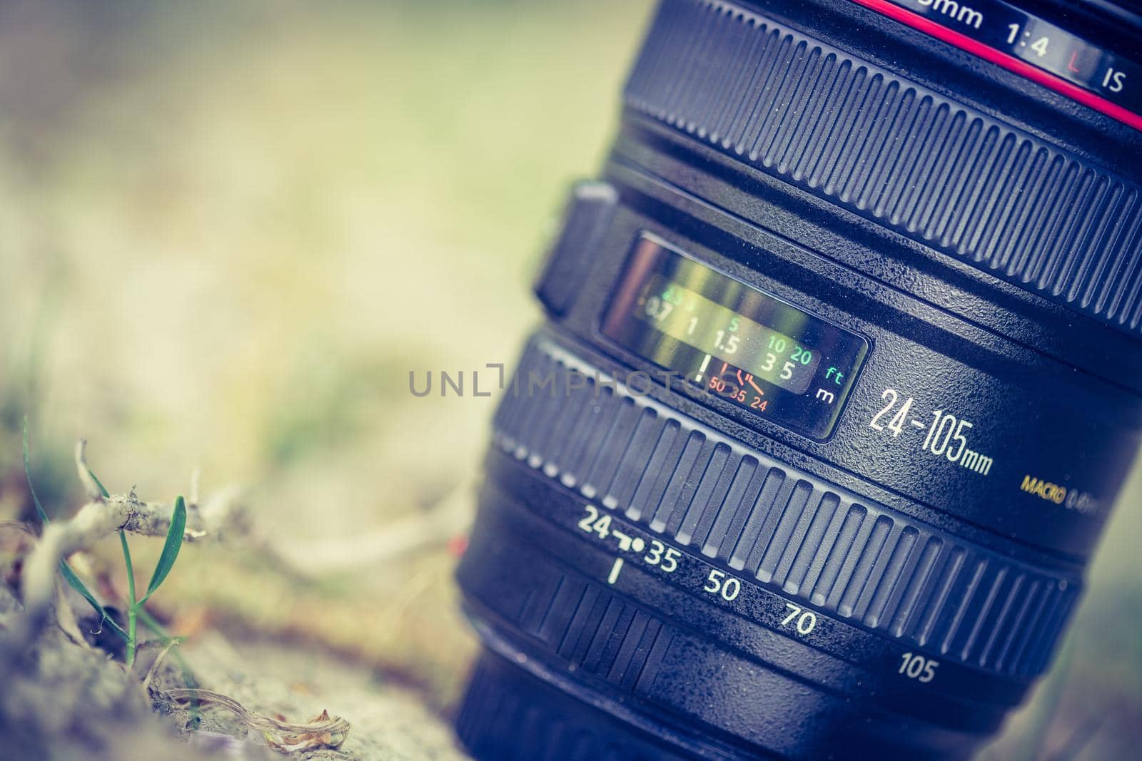 Professional optic photo lens outdoors. Warm colors, blurry background. by Daxenbichler