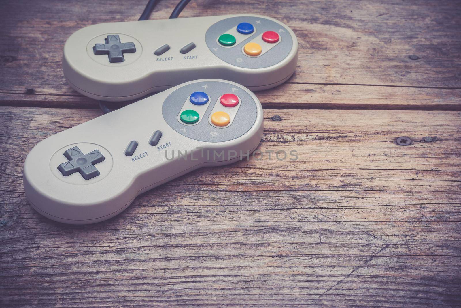 Retro computer gaming controller a rustic wooden background