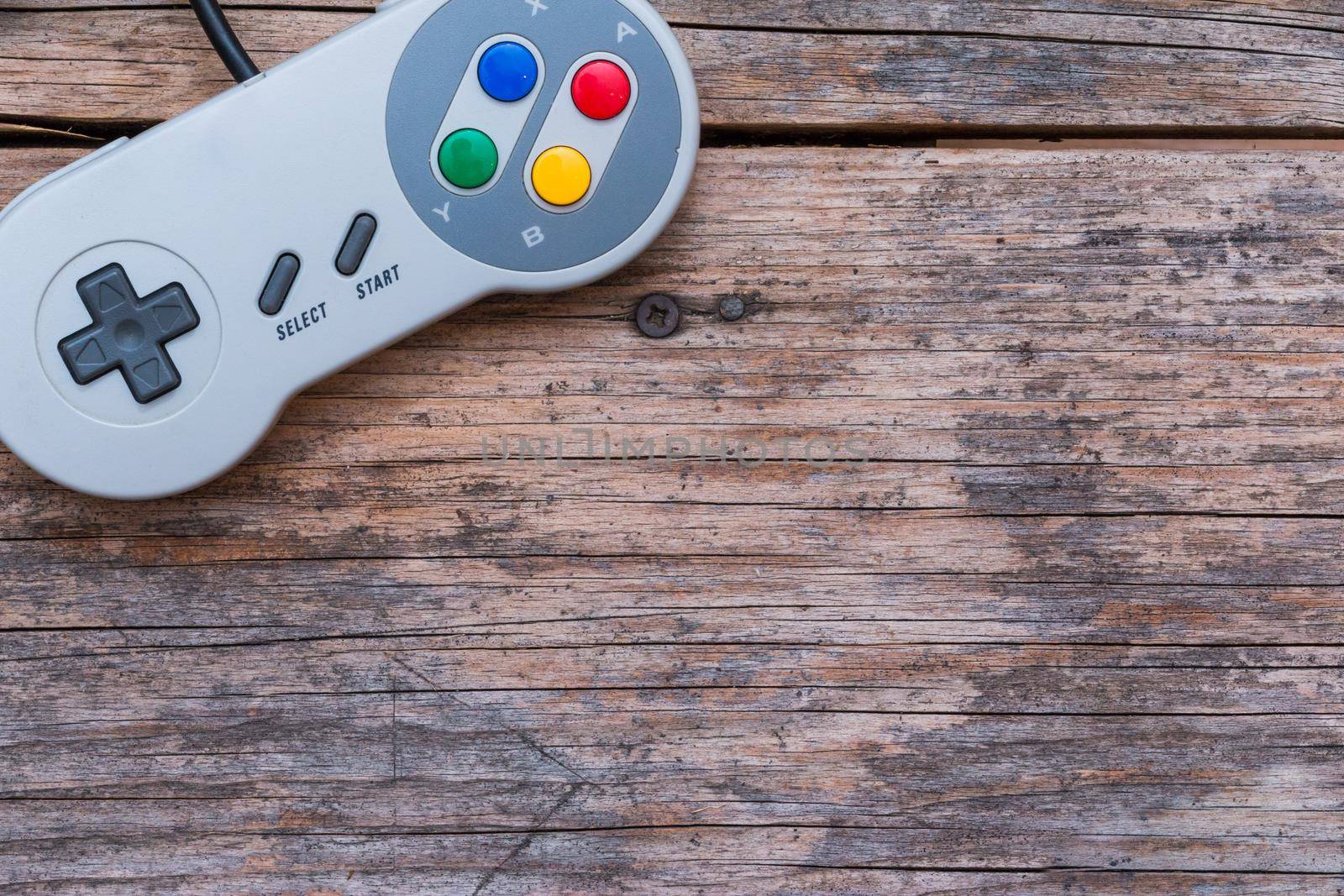 Retro computer gaming controller a rustic wooden background