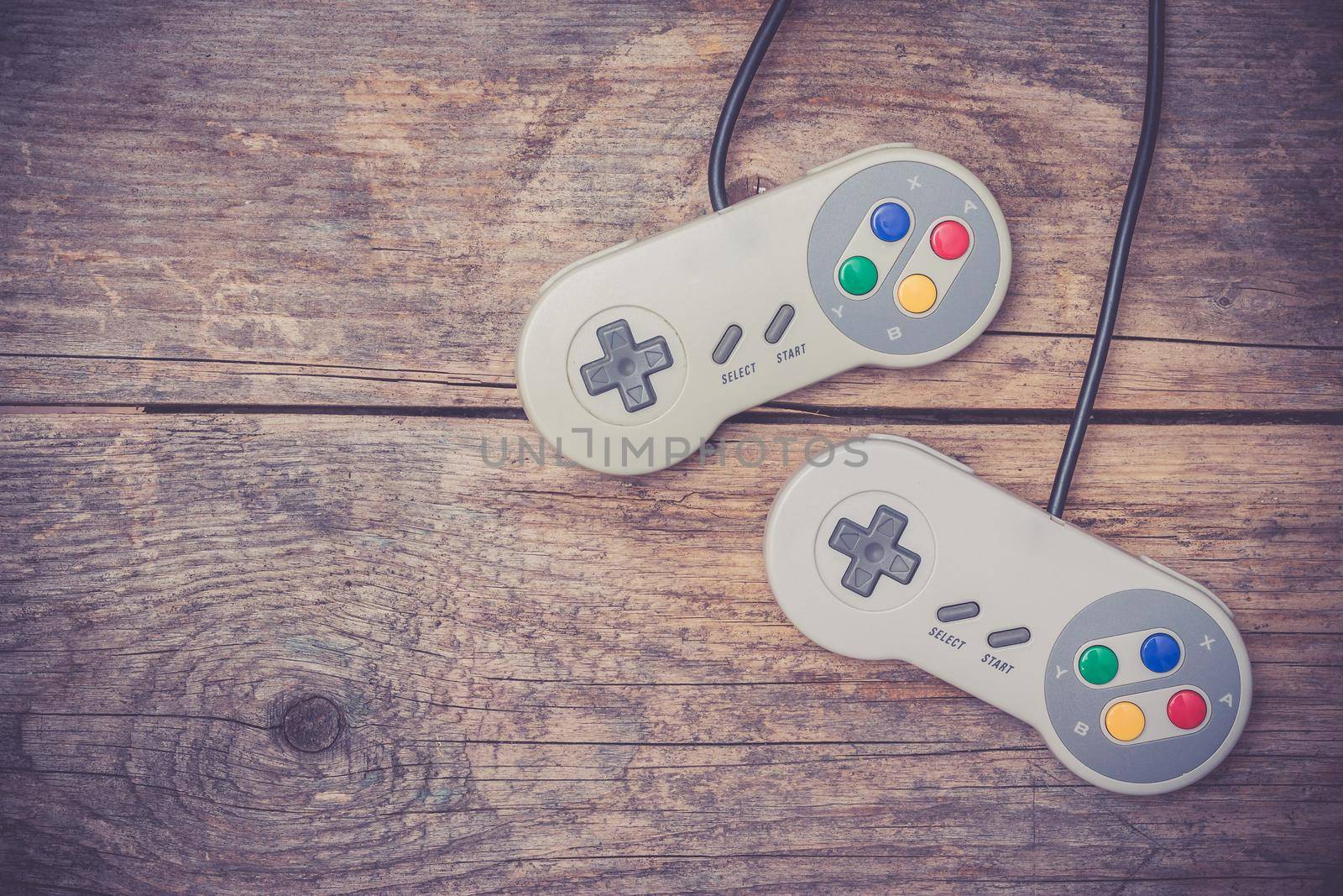 Retro computer gaming controller a rustic wooden background