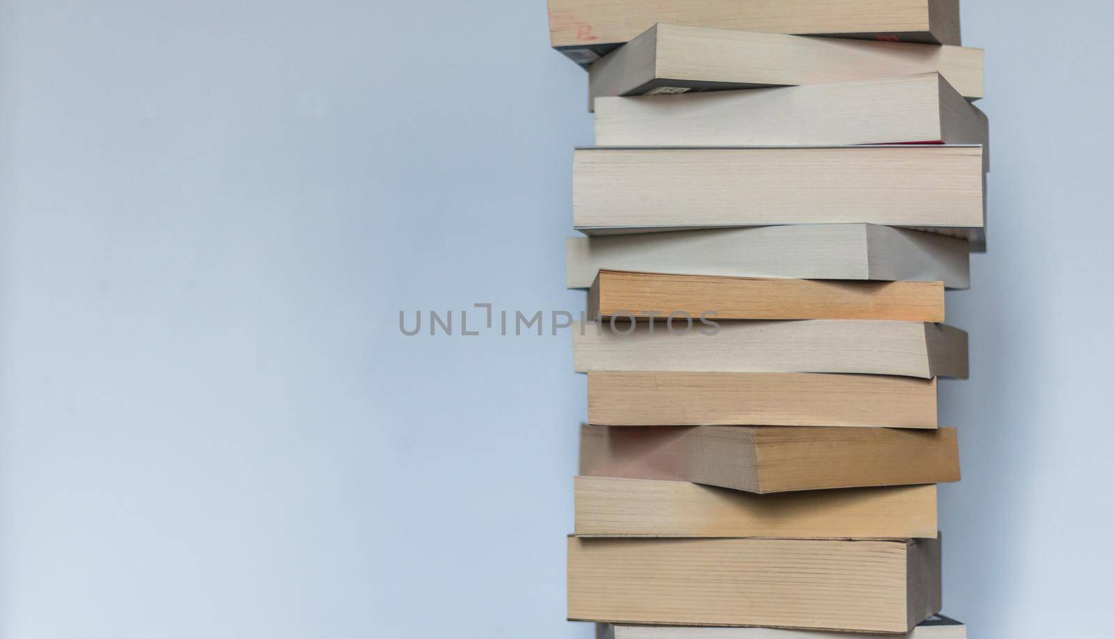 Knowledge and science concept: Stack of books, wooden background by Daxenbichler