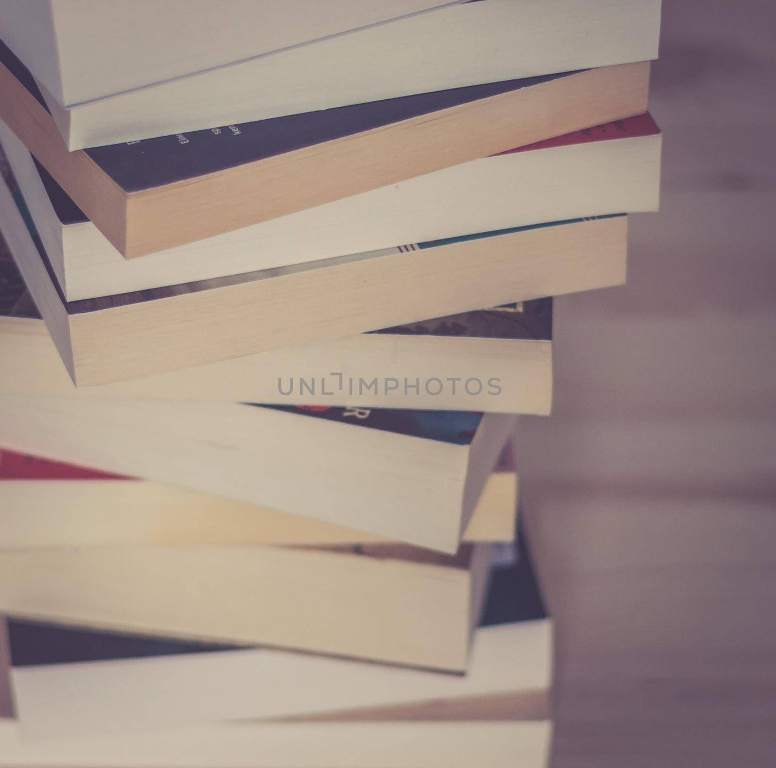 Knowledge and science concept: Stack of books, wooden background by Daxenbichler