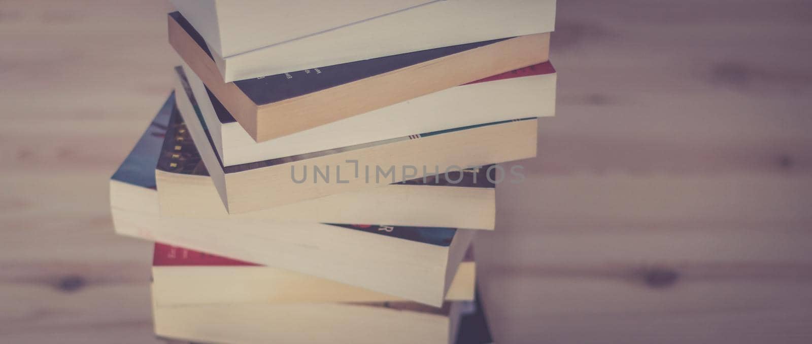 Knowledge and science concept: Stack of books, wooden background by Daxenbichler