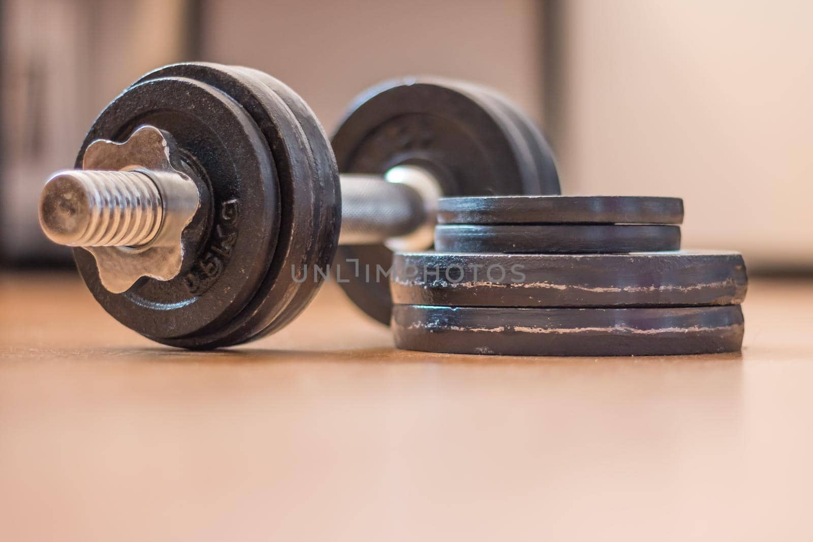 Black bar bell on the wooden floor, physical exercise