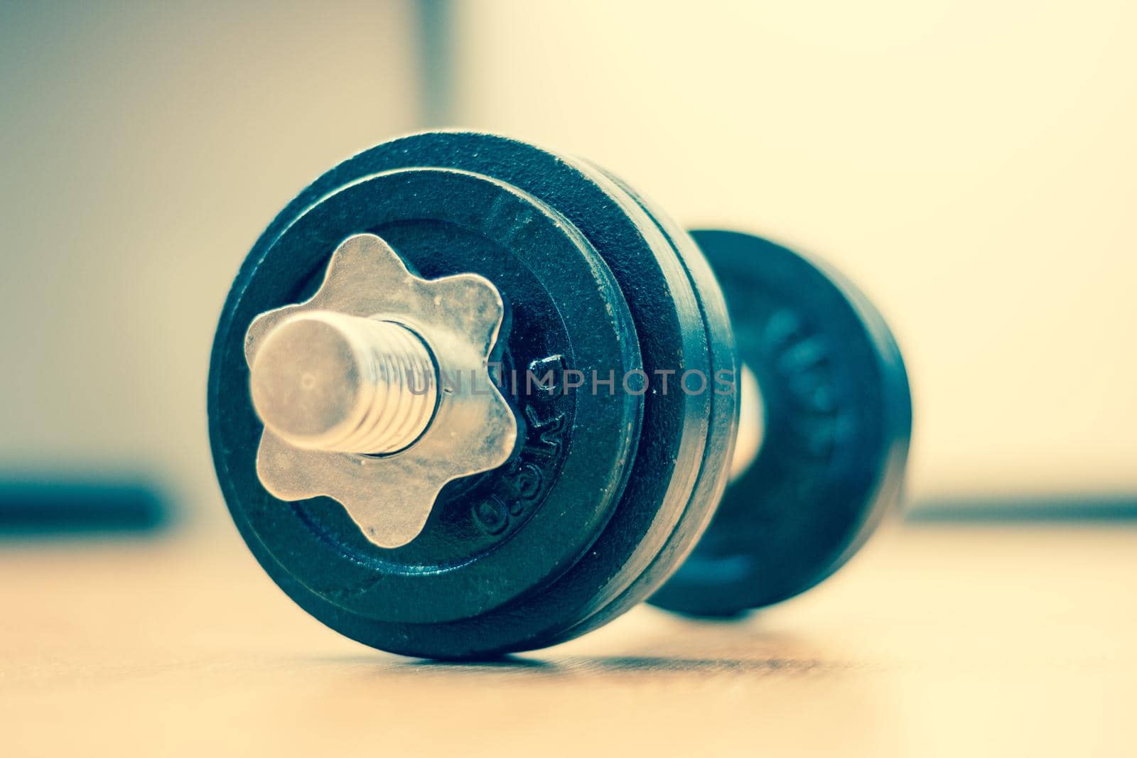 Black bar bell on the wooden floor, physical exercise