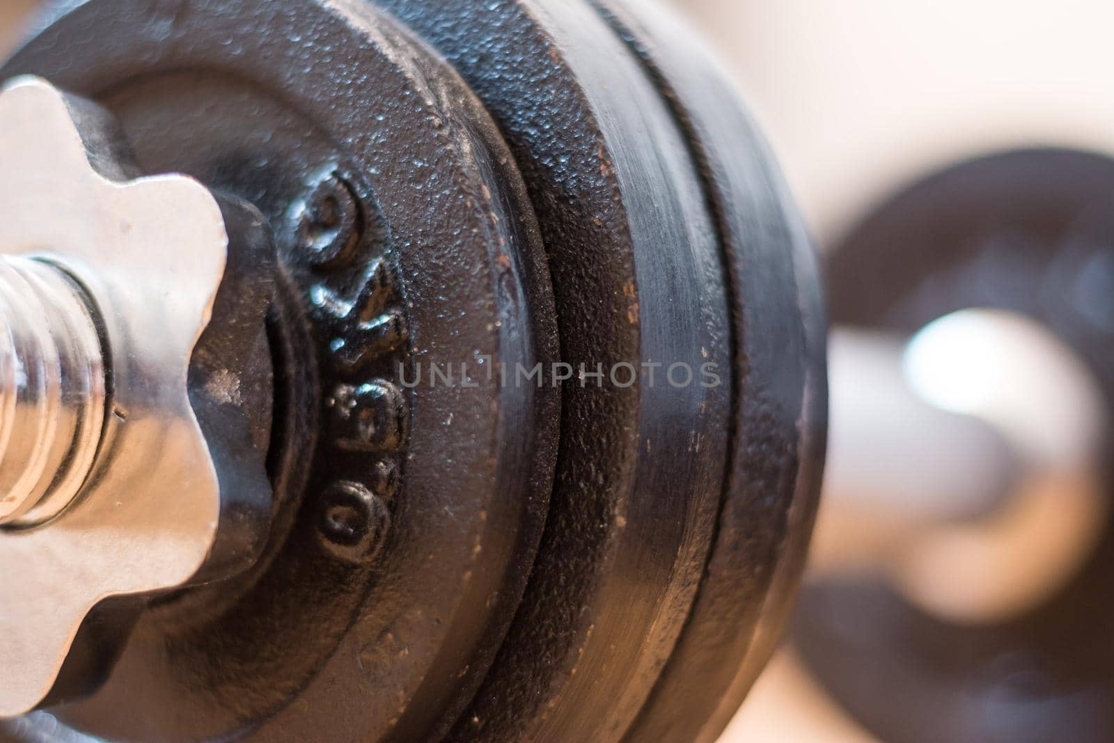 Black bar bell on the wooden floor, physical exercise