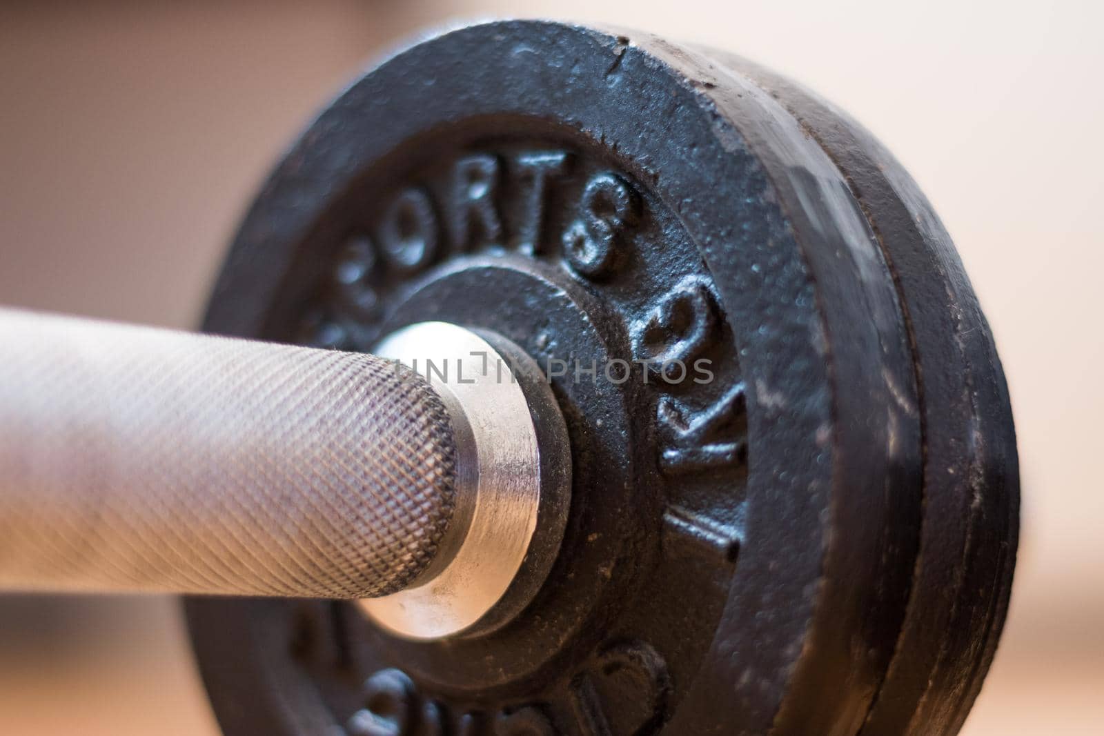 Black bar bell on the wooden floor, physical exercise