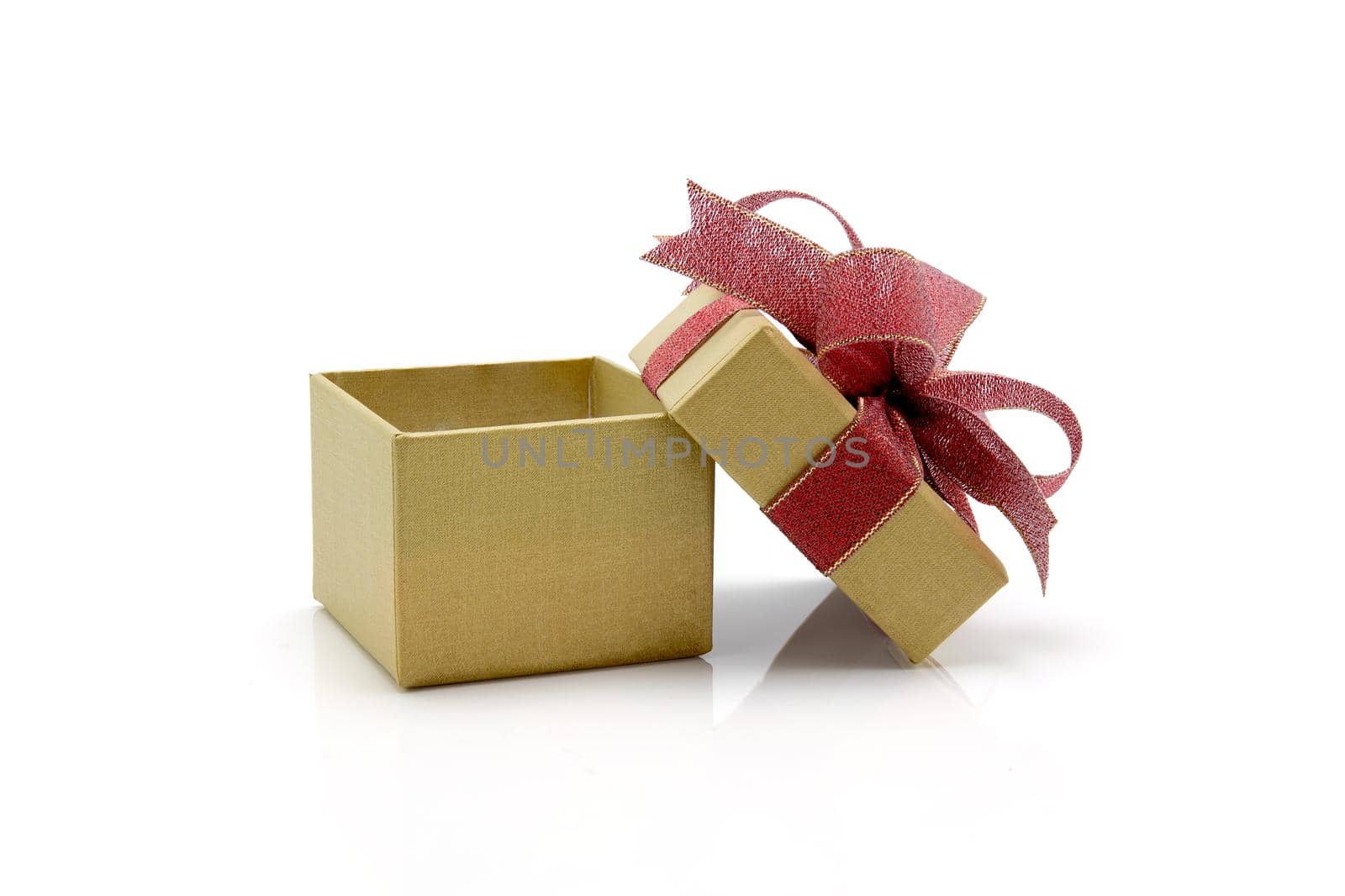 Gold gift box and ribbon open isolated on white background, presents in valentine day or Christmas day, object in birthday or anniversary, package with wrap luxury, holiday and festive concept.