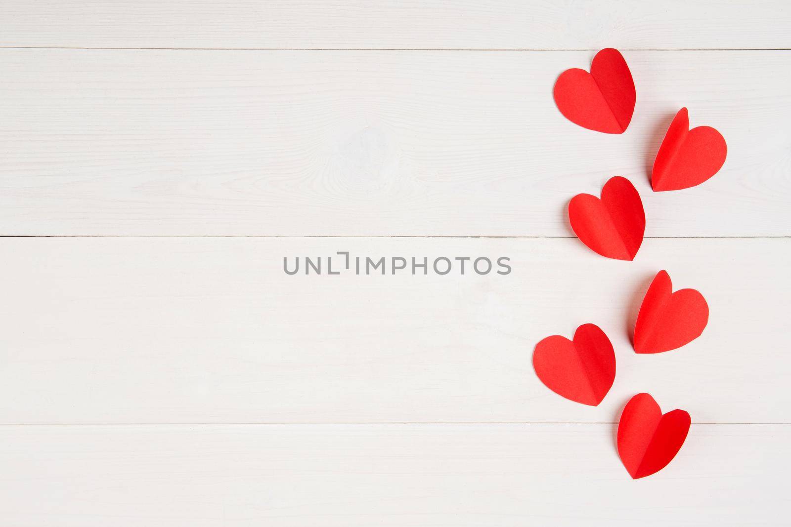 Heart shape with red paper on white wooden background, celebration and anniversary with symbol of love, holiday and festive, top view, flat lay, copyspace, valentine day concept.