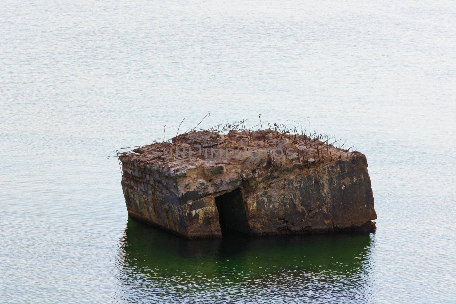 Old German bunker is rinsed out in the sea on the cliffs of the Baltic coast