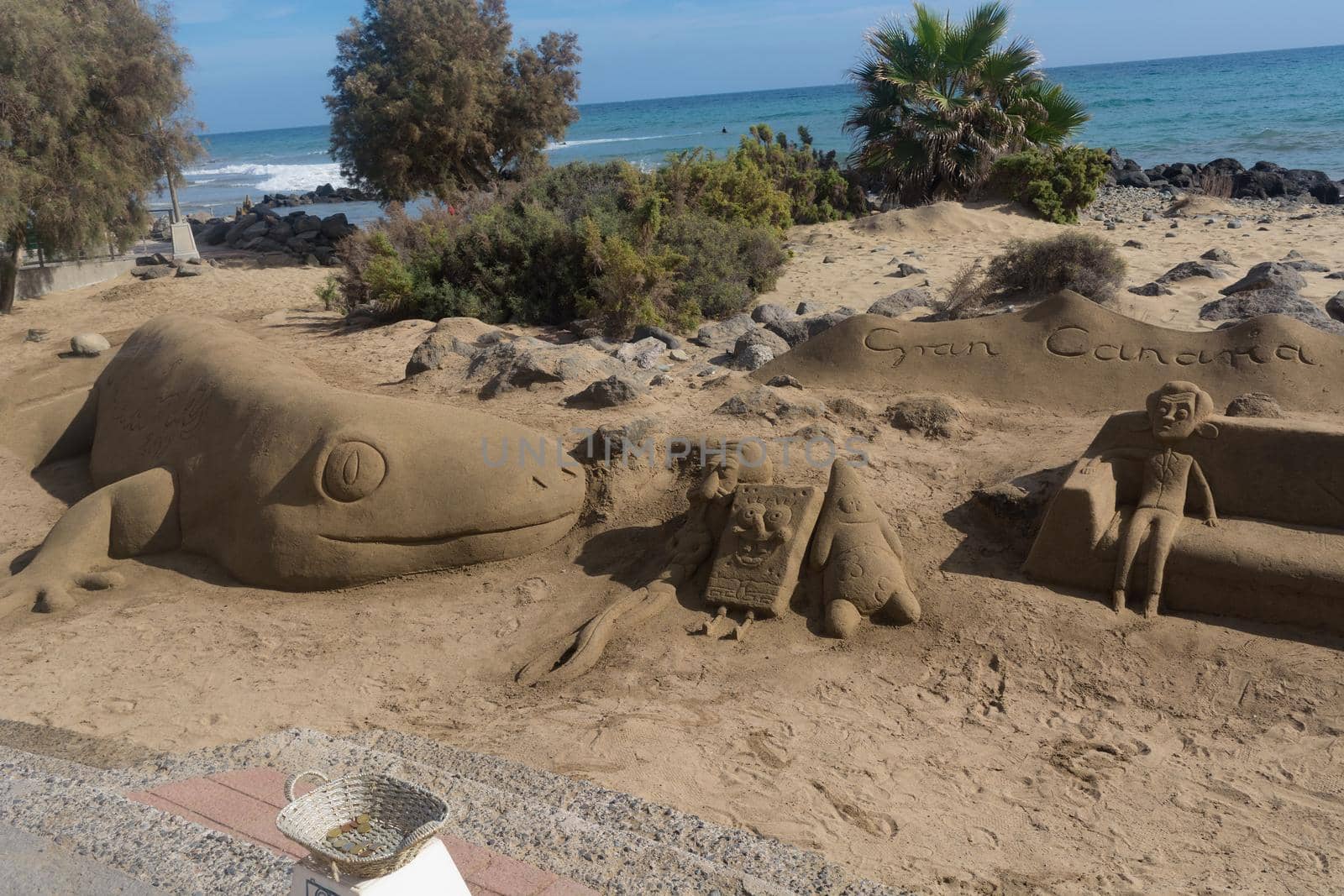 Sand sculptures on the beach of Meloneras, Spain with inscription Gran Canaria