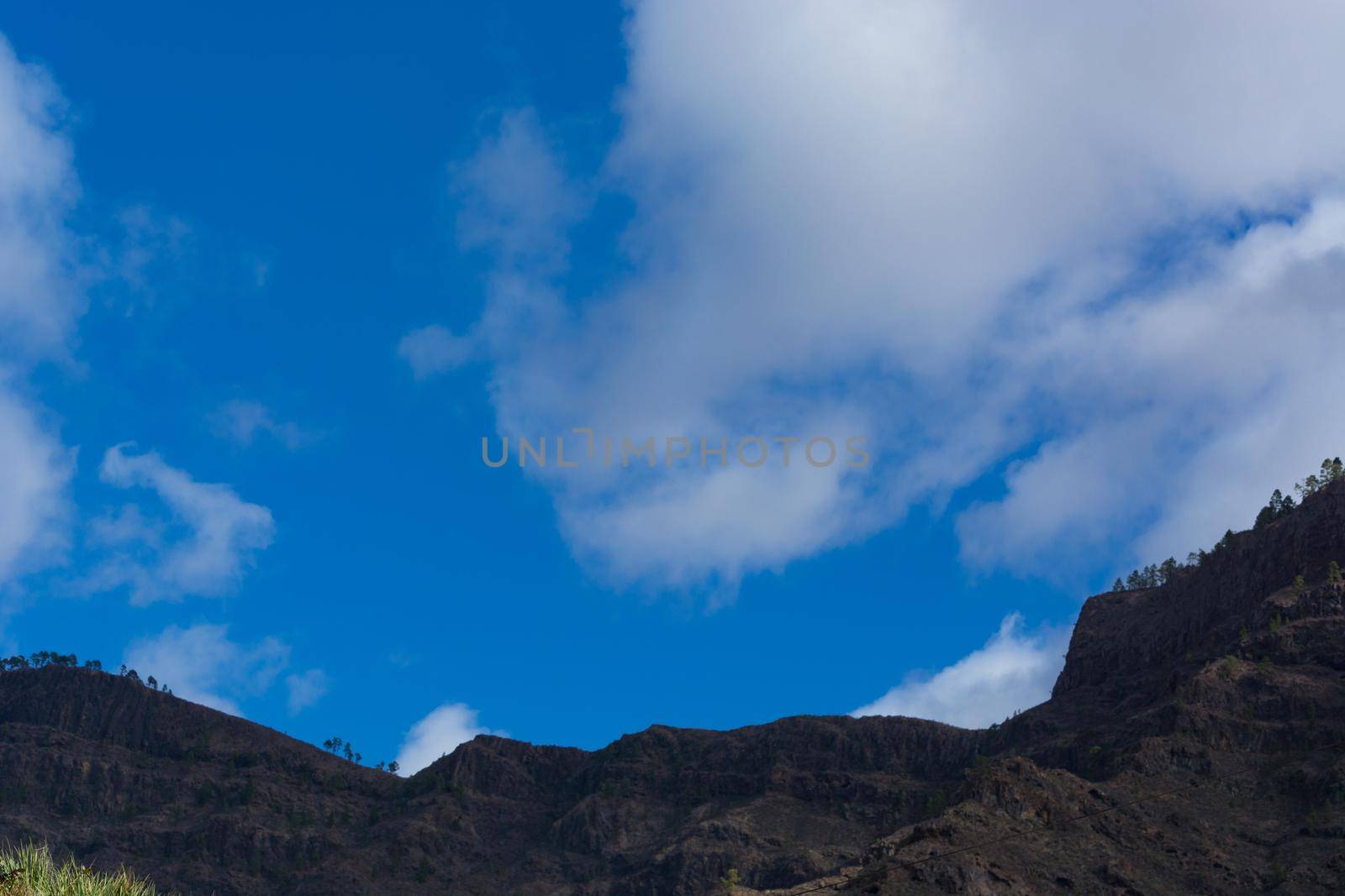 Mountains on the coast between Puerto de Mogan and Puerto Rico. Layers of volcanic rock.