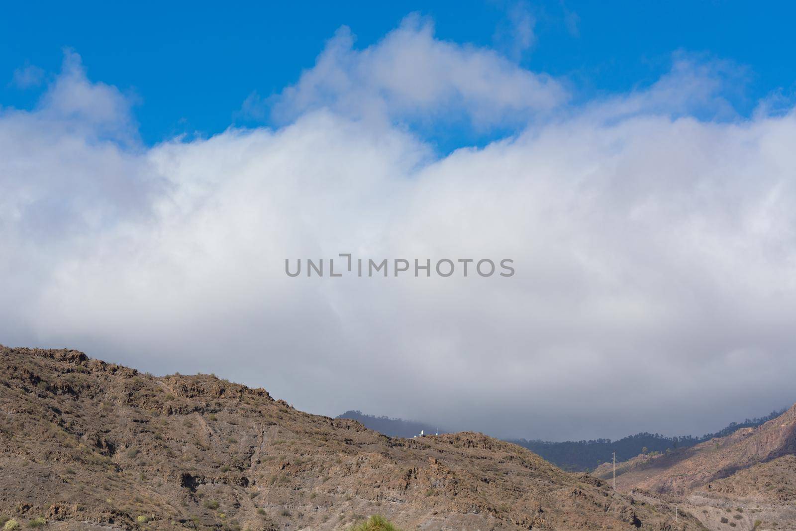 Mountains on the coast between Puerto de Mogan and Puerto Rico. Layers of volcanic rock.