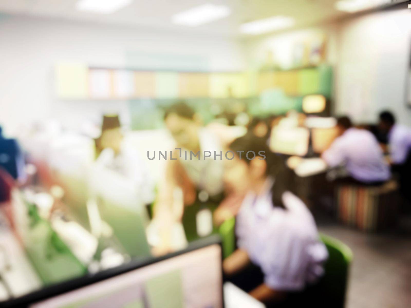 Blurred image of group of students are learning and sitting at desk using computer lap together in classroom for study and workshop in computers room at secondary school. education technology concept. by NarinNonthamand