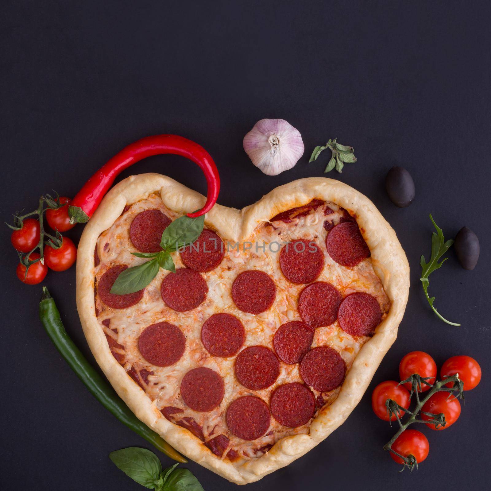 Pizza heart shaped with pepperoni by destillat