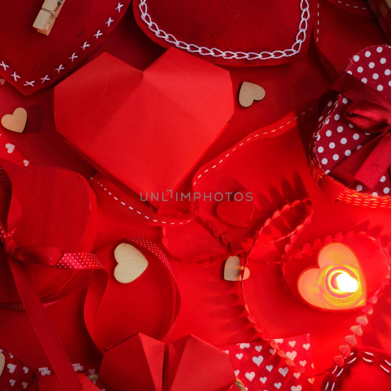 Many valentine day hearts and decor, homemade craft concept, red fabric, paper, gifts and candles