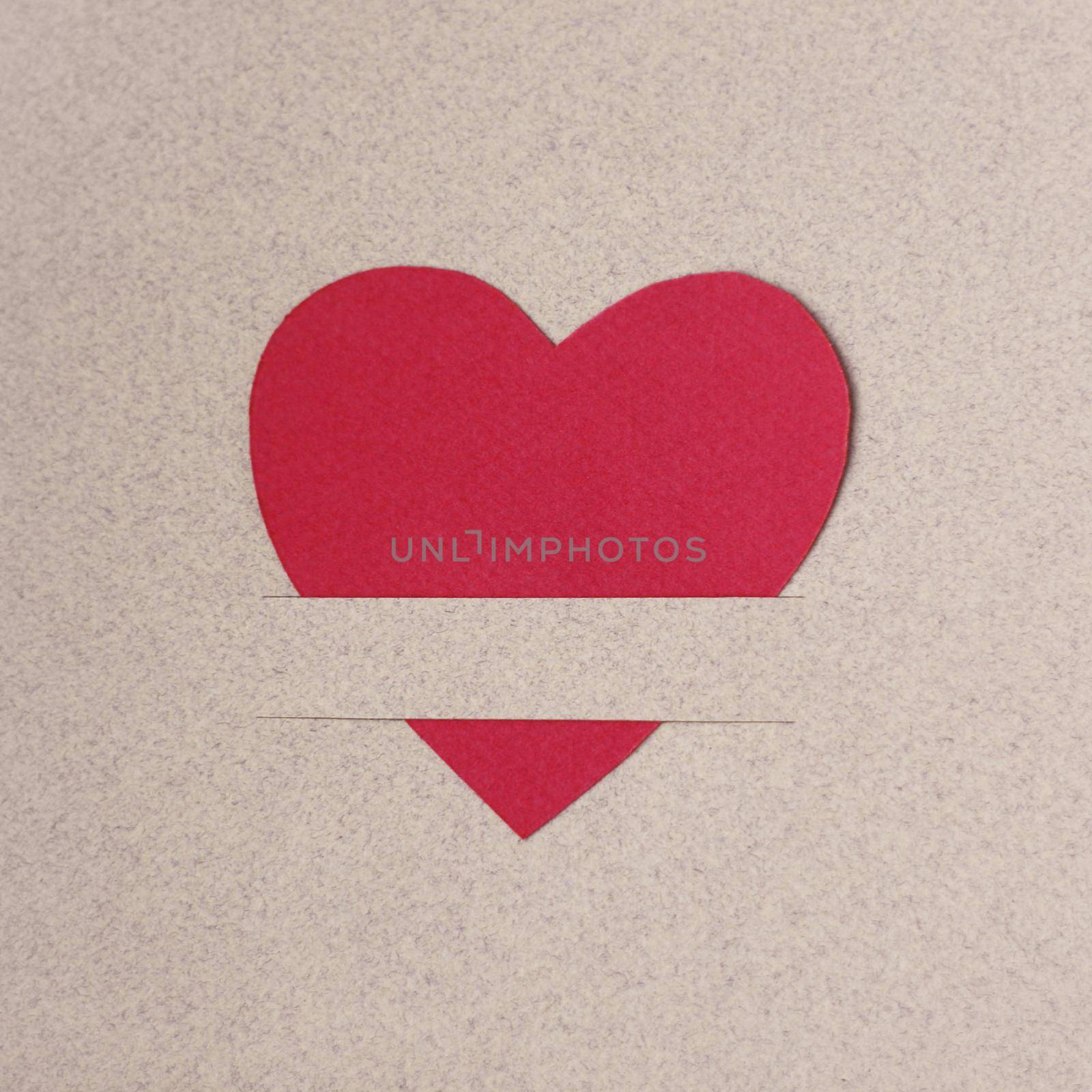 Red paper hearts on light paper textured background